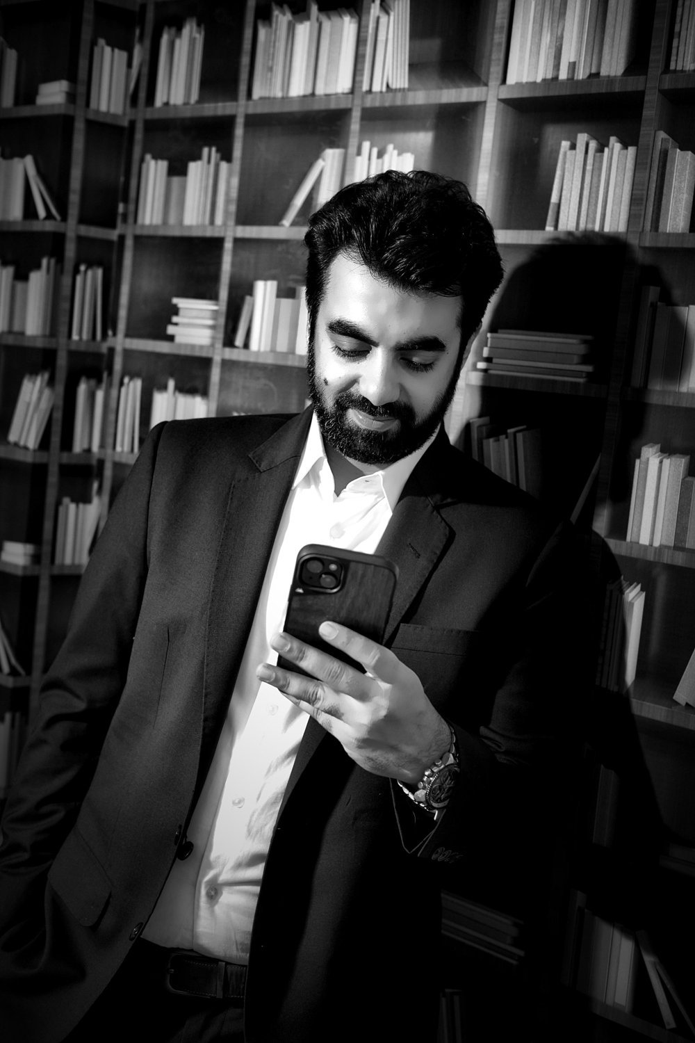 Ghulam Murtaza Memon checking his phone